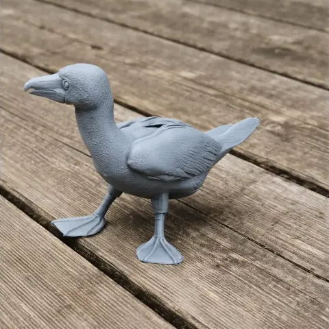 3D-printed gray blue-footed booby model on wooden surface.