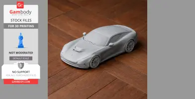 Gray 3D printed model of a sleek sports car on a wooden surface.