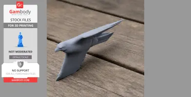 A 3D printed model of a booted eagle, set on a wooden surface.