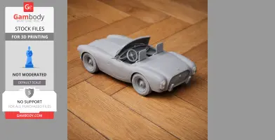 3D printed model of a vintage convertible car on a wooden floor.