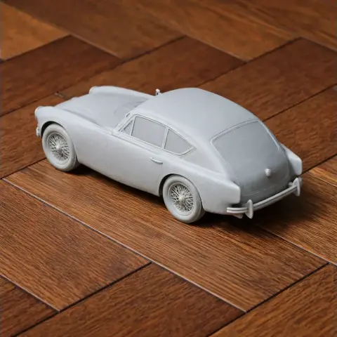 3D printed model of a classic AC Aceca car on a wooden surface.