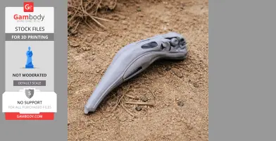 3D printed Andean flamingo skull replica lying on sandy ground.