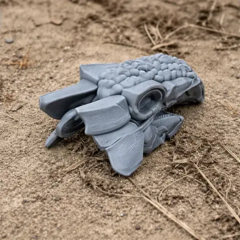 3D printed Ankylosaurus skull replica placed on sandy ground.