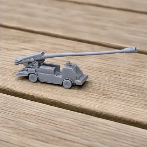 Gray 3D-printed tank model with a long barrel, displayed on a wooden surface.