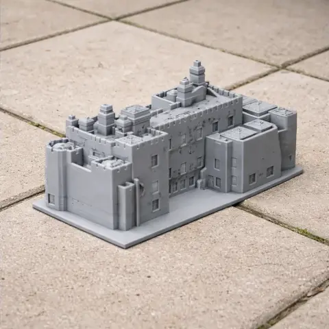 Miniature model of Affeton Castle with detailed architecture, placed on outdoor tiles.