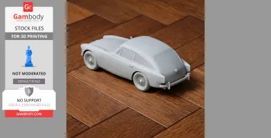 Gray 3D-printed model of AC Aceca car on a wooden surface.