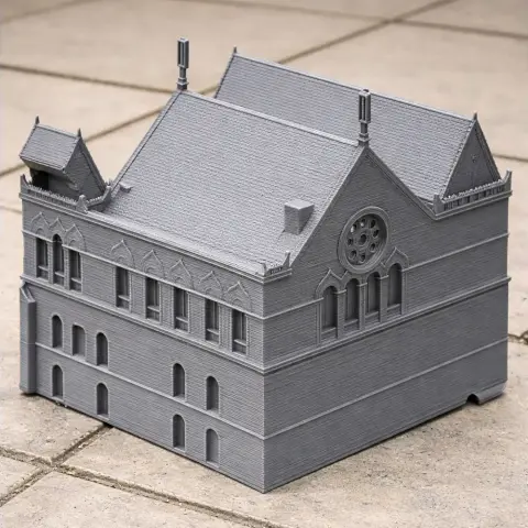 Gray 3D-printed model of a Gothic-style, two-story building with arched windows and detailed roof.