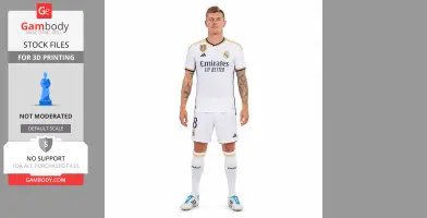 A person in a white soccer kit, standing upright, with tattoos on both arms visible.