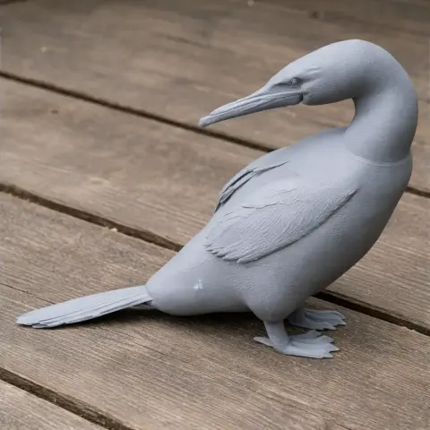 3D printed model of a flightless cormorant bird, posed on a wooden surface.