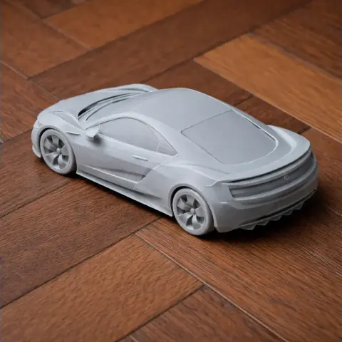 3D printed Acura NSX scale model in gray, displayed on a wooden surface.