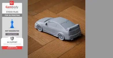 Gray 3D-printed model of an Acura RSX car on a wooden surface.