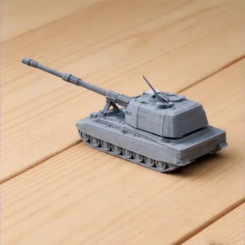 3D printed model of a tank with a long barrel on a wooden surface.