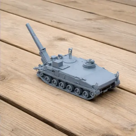 Gray 3D-printed tank model with a large rear cannon, displayed on a wooden surface.