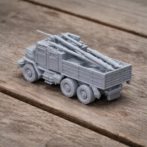 3D-printed model of a military truck with mounted artillery, displayed on a wooden surface.