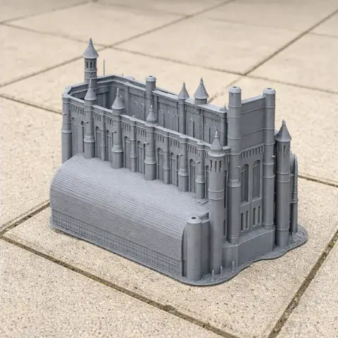 Detailed 3D printed model of Albi Cathedral with towers and arches, set on a tiled surface.