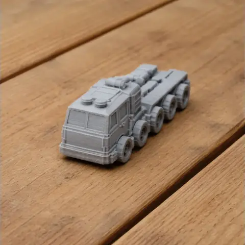 Gray 3D-printed model of a military vehicle with multiple wheels on a wooden surface.