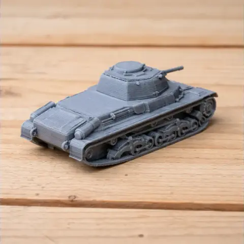 Gray 3D-printed model of a tank with turret and caterpillar tracks on a wooden surface.
