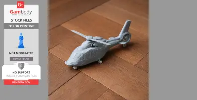 Gray 3D-printed model of an Airbus H160 helicopter on a wooden floor.