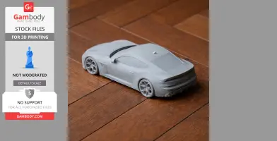 3D printed model of a sleek Alfa Romeo 6C car, placed on a wooden surface.