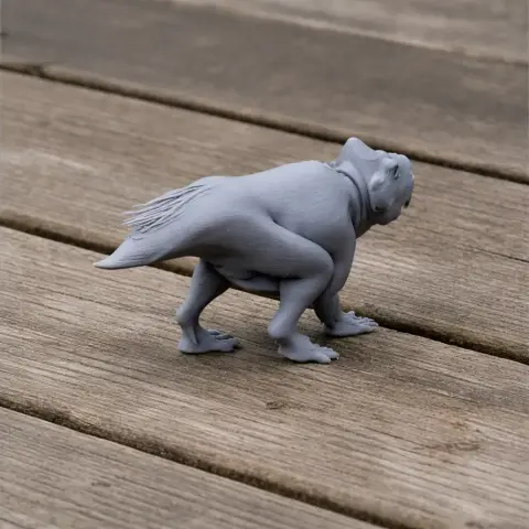 Gray 3D-printed model of a Montanoceratops dinosaur on a wooden surface.