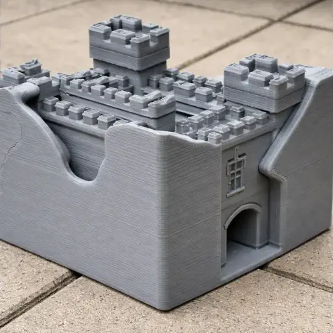 Gray 3D-printed model of a castle with towers and an arched entrance, resembling Alnwick Abbey.