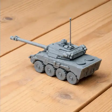 Gray 3D-printed tank model with detailed features and six wheels on a wooden surface.