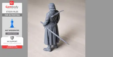 A gray 3D printed figurine of a cloaked warrior holding a sword on his back.