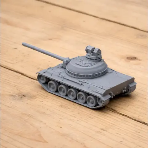 3D-printed AMX-30 tank model on a wooden surface, showing turret and tracks.