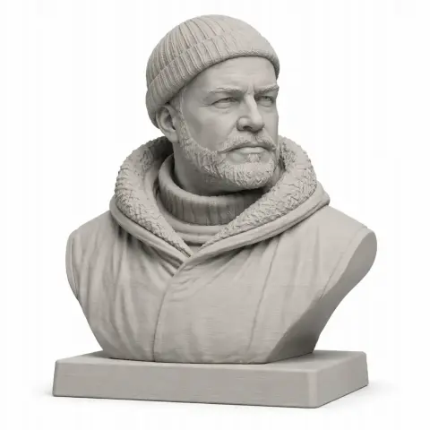 Bust of a bearded man in winter attire, wearing a knit cap, on a rectangular base.