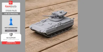 3D-printed gray tank model with turret and cannon on a wooden surface.