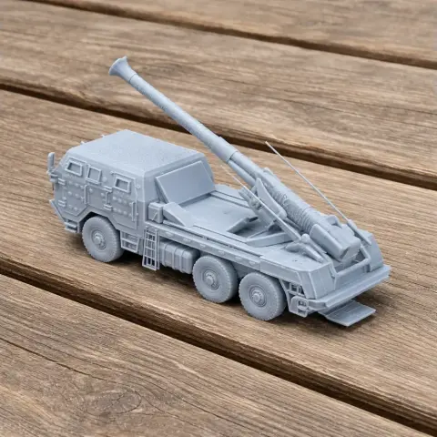 A detailed 3D-printed model of a military tank with a long barrel and six wheels on wooden surface.