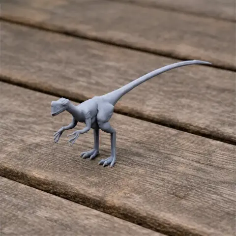 Gray 3D-printed dinosaur model with a long tail and slender limbs on a wooden surface.