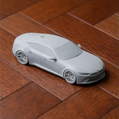 3D-printed Alfa Romeo Giulia model car on a wooden surface.