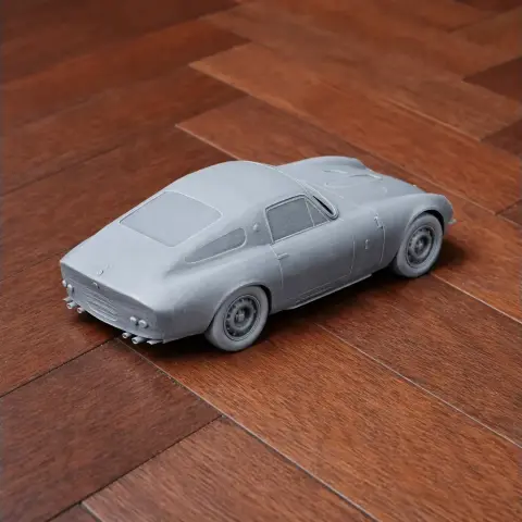 3D-printed gray model of an Alfa Romeo Giulia TZ on a wooden floor.