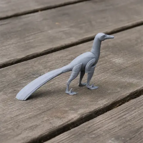 Gray 3D-printed model of a Neuquenraptor dinosaur standing on a wooden surface.