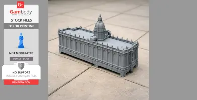 A detailed gray 3D-printed model of a building with ornate details and a central dome, placed outdoors.