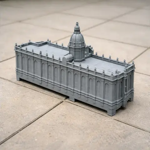 Gray 3D-printed model of a neoclassical building with a central dome on a tiled surface.