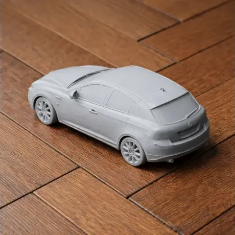 3D printed scale model of a 2010 Alfa Romeo Giulietta on a wooden surface.