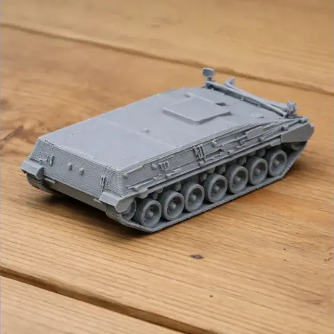 Gray 3D-printed model of a Begleitpanzer 57 tank on a wooden surface.