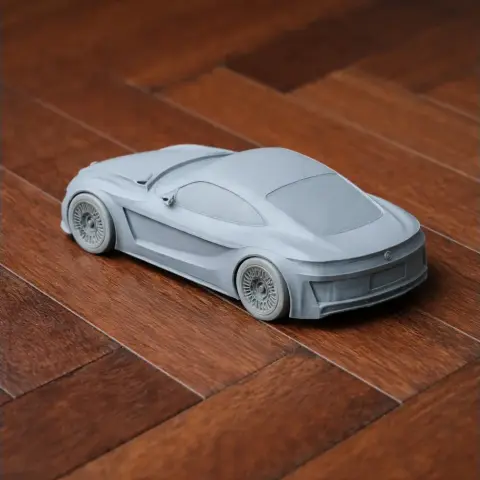 3D-printed scale model of an Alfa Romeo Gloria, displayed on a wooden surface.