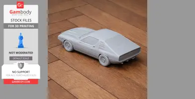 3D-printed model of an Alfa Romeo Montreal car on a wooden surface, viewed from the rear side.