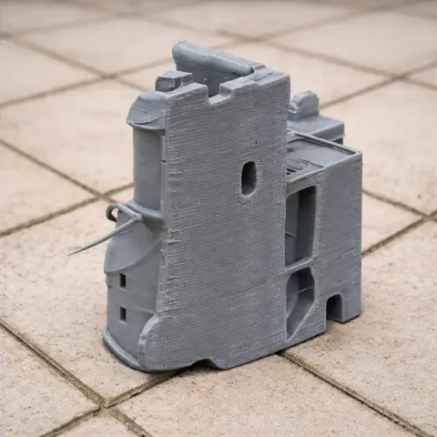 3D-printed gray model of Ashby de la Zouch Castle with visible tower and windows on a tiled floor.