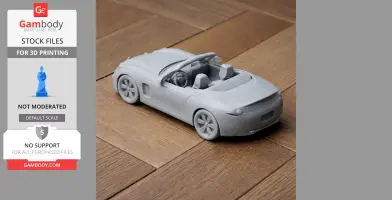 3D-printed scale model of an Alfa Romeo Nuvola convertible on a wooden surface.