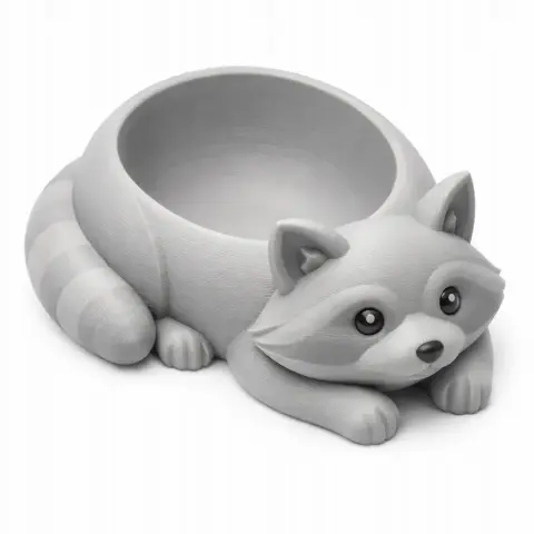 A raccoon-shaped bowl and wall hook with a hollow body for holding items.