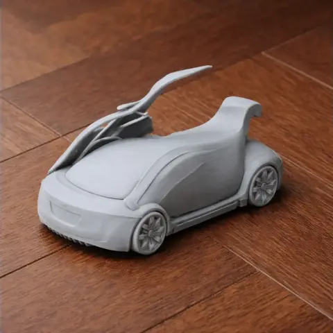 3D printed model of a futuristic car with open gullwing doors, placed on a wooden surface.