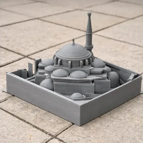 3D-printed model of a domed palace with arches and minarets, displayed on a tiled surface.