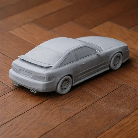 3D printed Alfa Romeo SZ model on a wooden surface, showcasing detailed rear and side views.