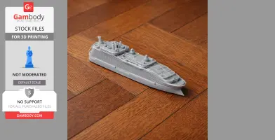 A small 3D-printed model of a cruise ship on a wooden floor.