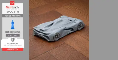3D-printed model of a sleek Alpine sports car, displayed on a wooden surface.