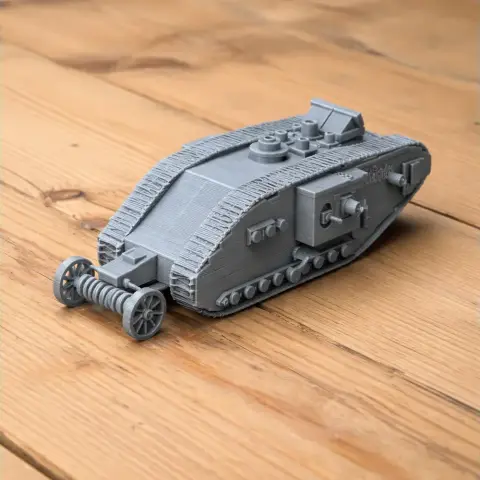 Gray 3D-printed model of a WWI British heavy tank on a wooden surface.